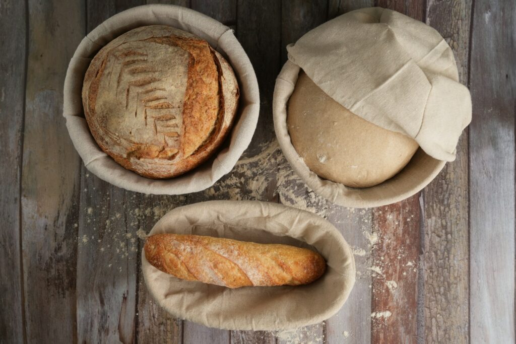 A table topped with bread and a loaf of bread