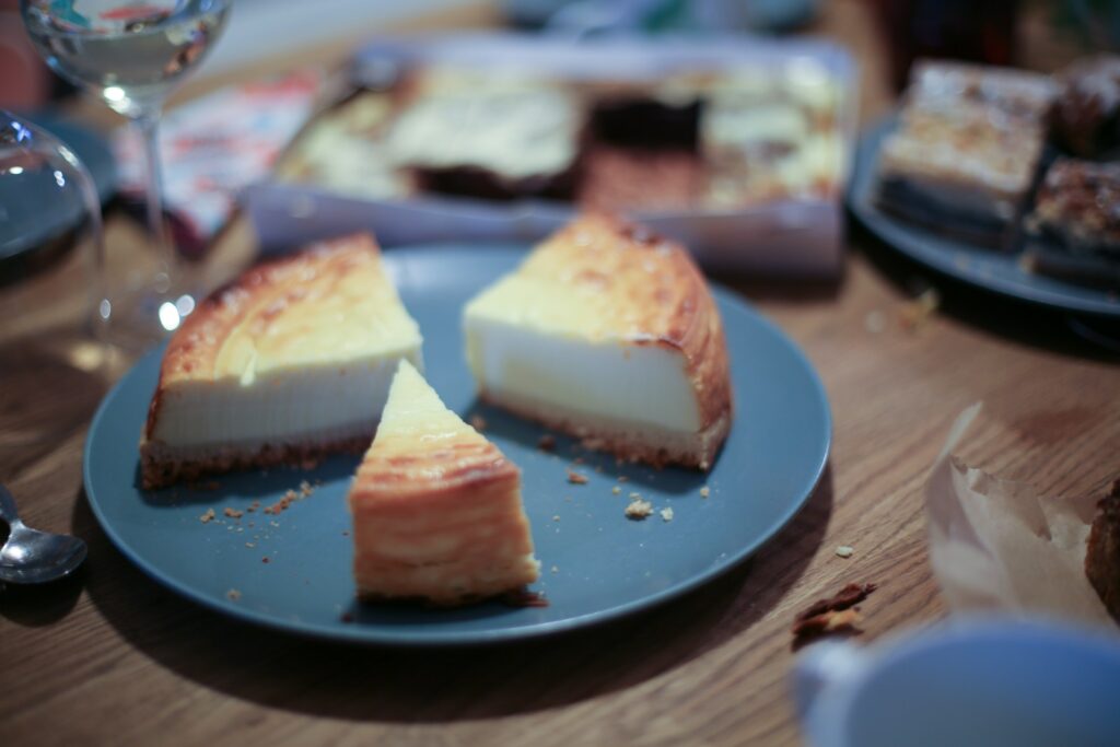 a blue plate topped with slices of cheesecake